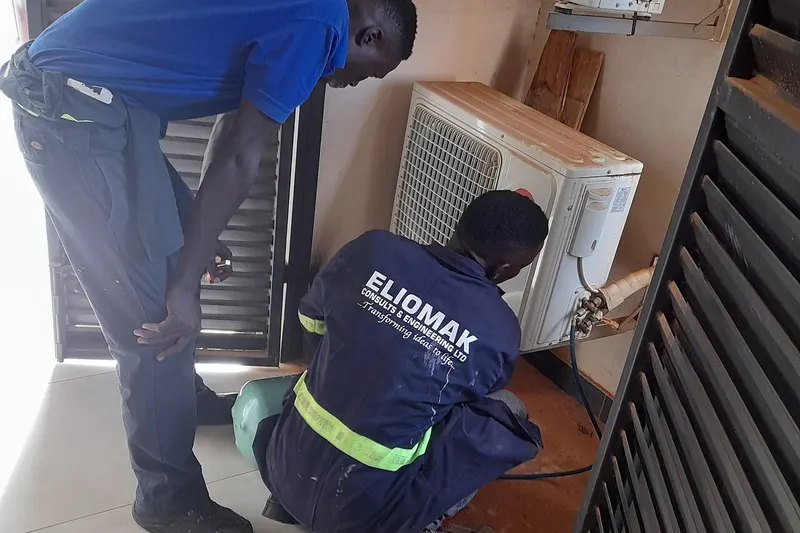 Technician servicing an inverter air conditioning and heat pump system in Malta